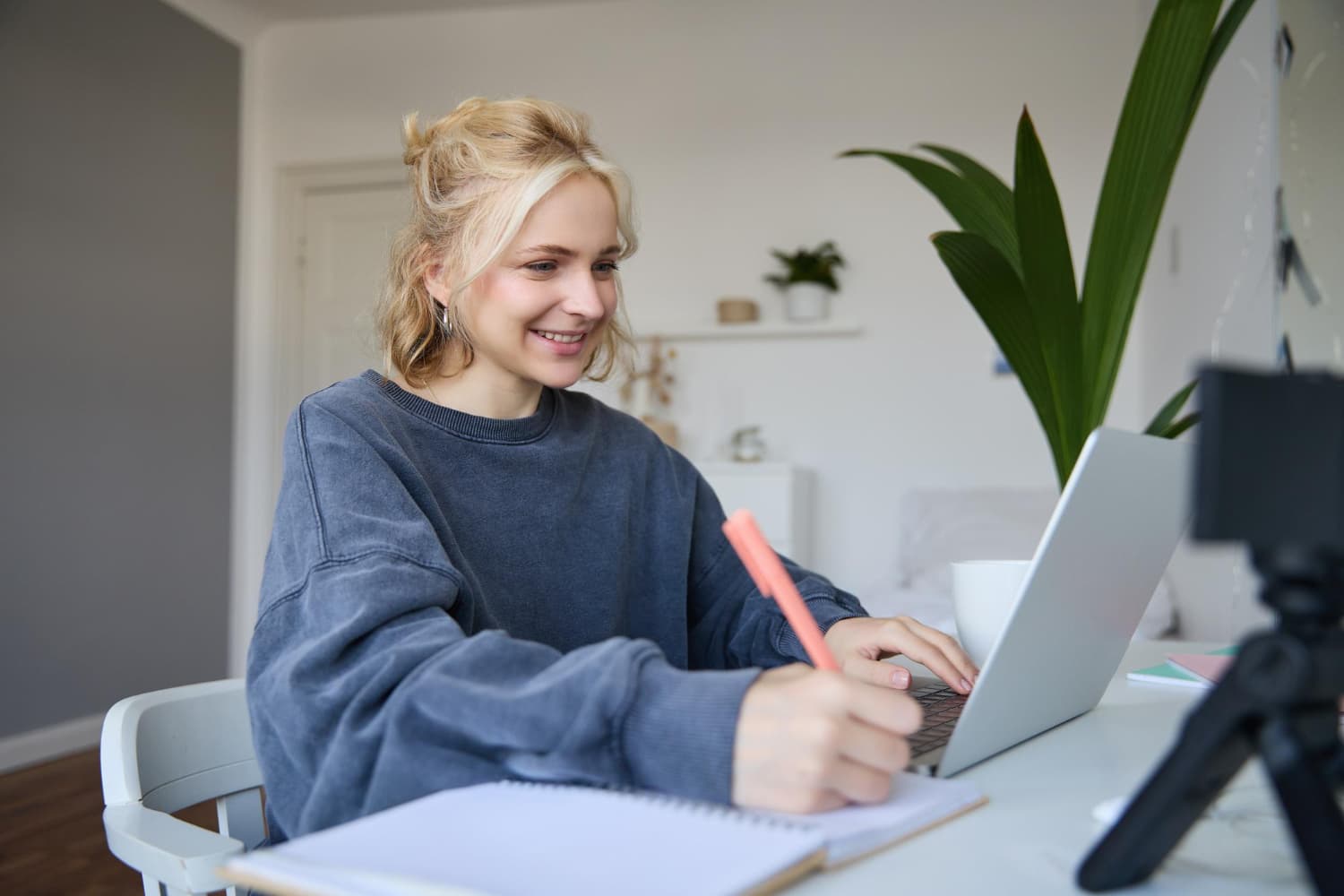 A learner studying Norwegian at a sunlit desk